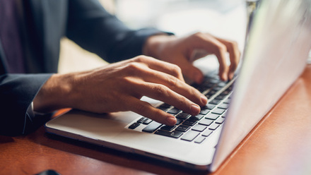 Person's hands on laptop keyboard.jpg